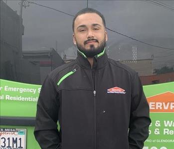 Adrian standing in front of Servpro truck