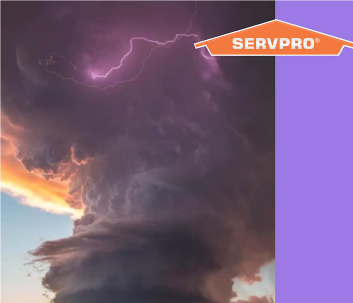 A huge storm cloud that looks like a tornado with lightning.