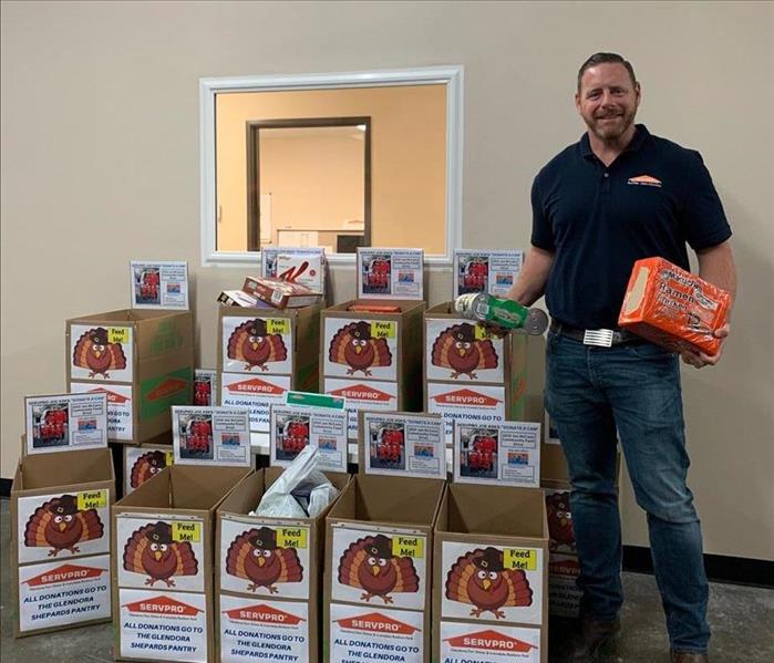 Joe McCann with the canned food collected in November